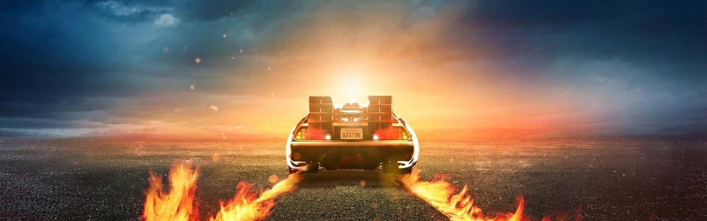 The DeLorean from Back to the Future driving down a road into a fiery sunset.
